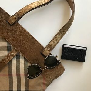 Burberry metallic stowell roll-up tote.